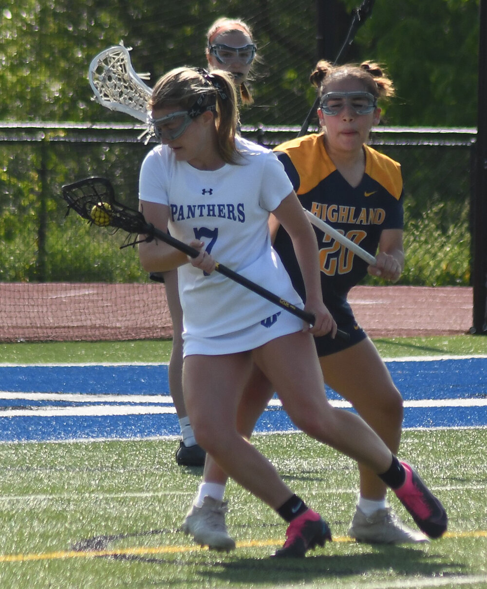 Wallkill's Emma DiLemme maneuvers around the defense of Highland's Jessica Rendon during Thursday's non-league girls' lacrosse game at Wallkill High School.