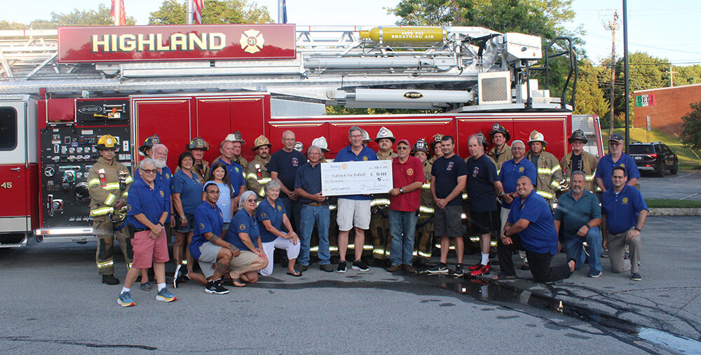 Highland Rotary Club president Steve Laubach, with Highland firefighters and Rotary Club members. Fundraising events and sponsorships generated $10,000 to purchase much needed safety equipment for the district.