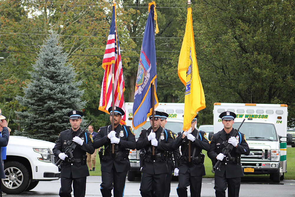 The New Windsor Police Department Color Guard march displaying the colors as first responders, veterans and families salute.