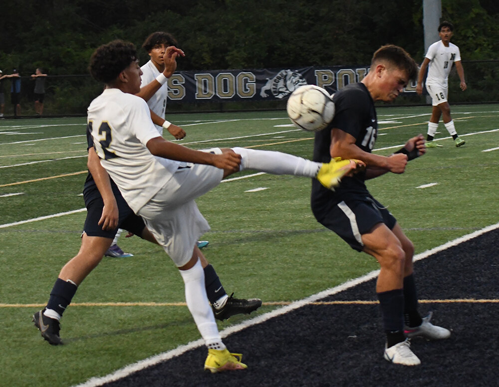 Newburgh's Jose Torres kicks the ball away from Beacon's Avery Davis during Wednesday's non-league boys' soccer game at Beacon High School.