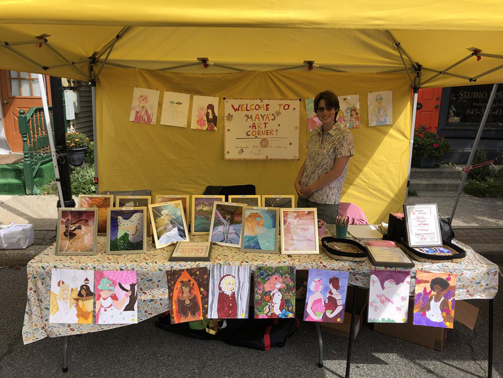 Maya Sullivan showcasing and selling her art at the festival.