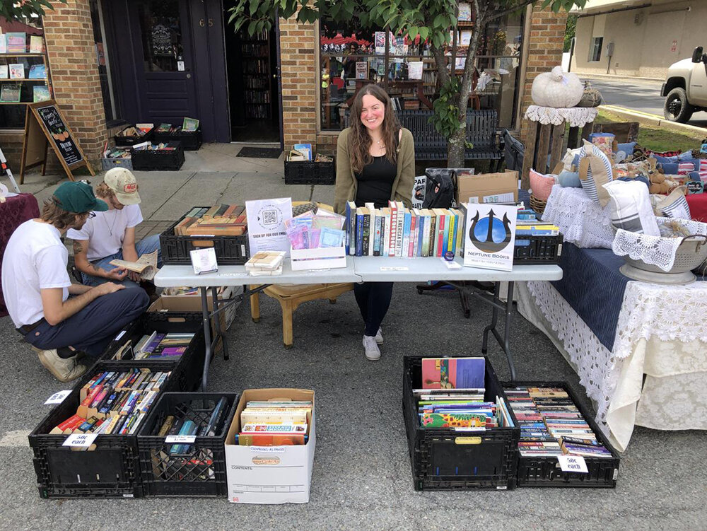 Shannon selling literature at Neptune Books’ stand.