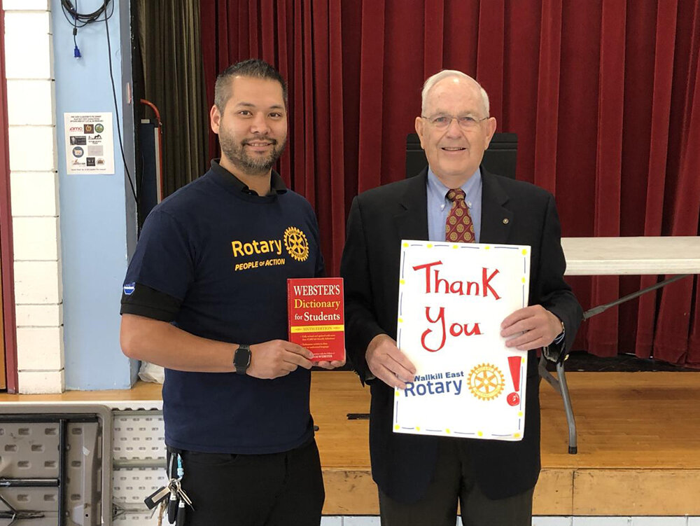 Andrew Allen (left) holding dictionary and Bassett (right) holding a card from Pine Bush Elementary’s students thanking the Rotary Club