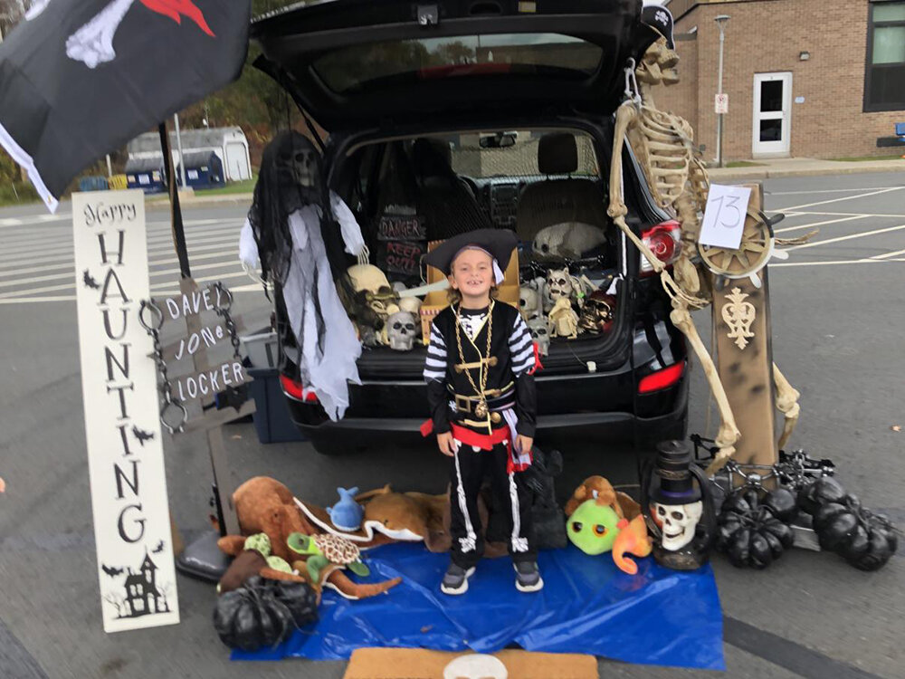 Louie standing in front of his grandmother’s pirate-themed trunk