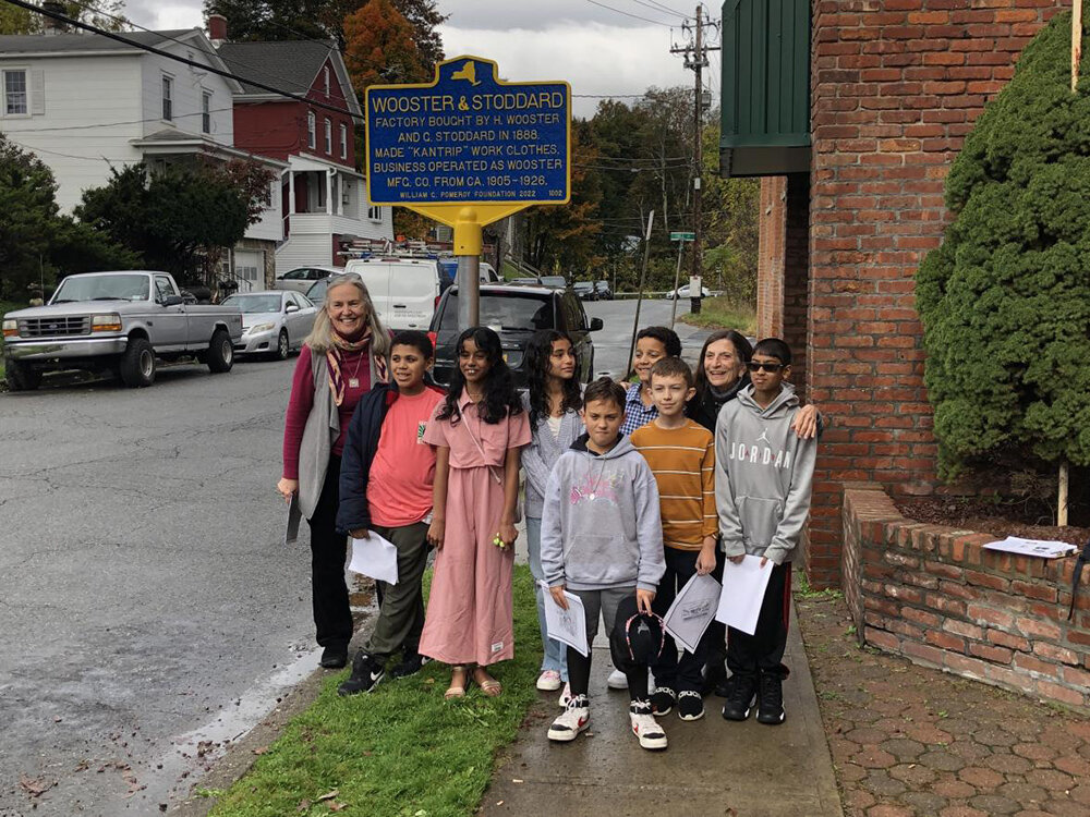 Nancy Phelps and the history club posing in front of the marker.
