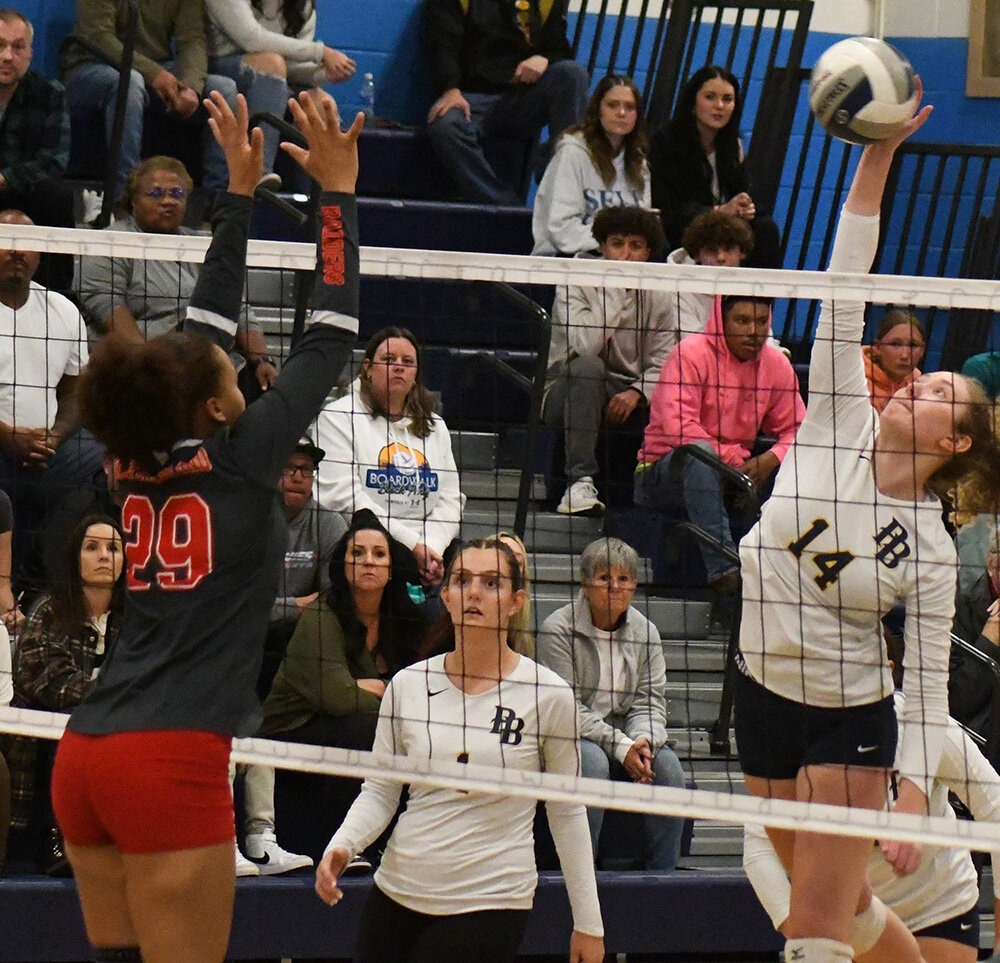 Pine Bush's Ellie Hoppe hits the ball over the net as North Rockland's Yulis Vidal defends and Pine Bush's Kendall Morris looks on during Wednesday's NYSPHSAA Class AAA subregional at Wallkill High School.
