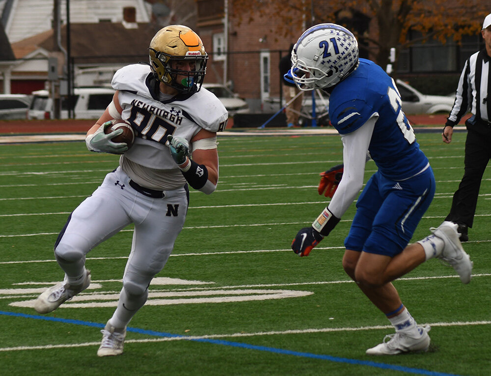 Newburgh's Christopher Leggett turns downfield as Middletown's Jared Howell closes in during Saturday's Section 9 Class AA championship football game at Academy Field in Newburgh.