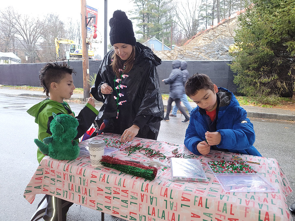 Sherida Sessa (center) of the Marlborough Town Board and its Recreation Committee, staffed a booth for kids to make holiday ornaments with beads. With her are her son, Jaxson (L) and his friend Caden Heavens.