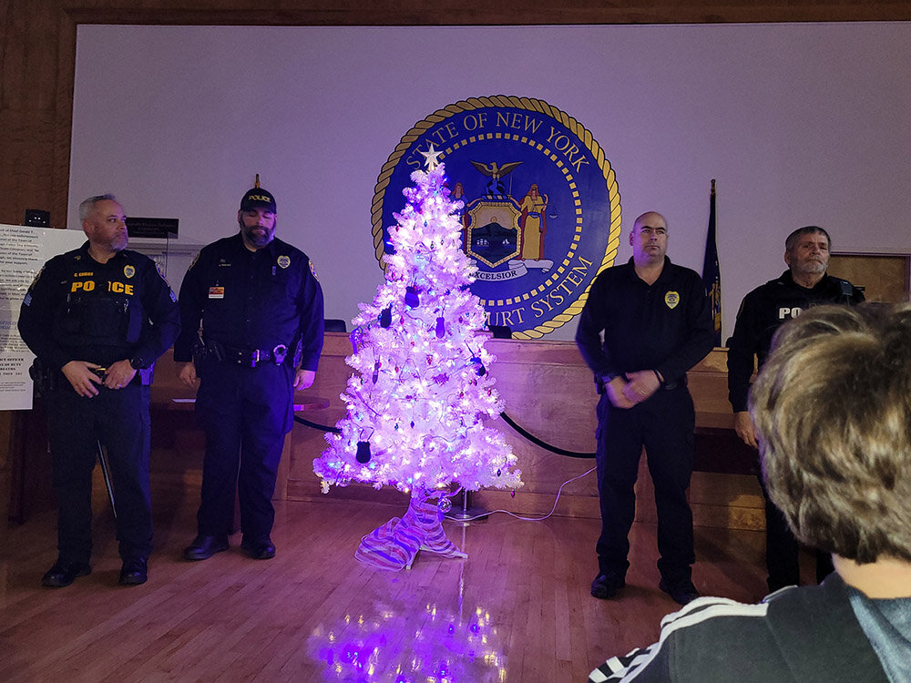 Marlborough Police stand next to Marlborough’s tree commemorating fallen police officers.