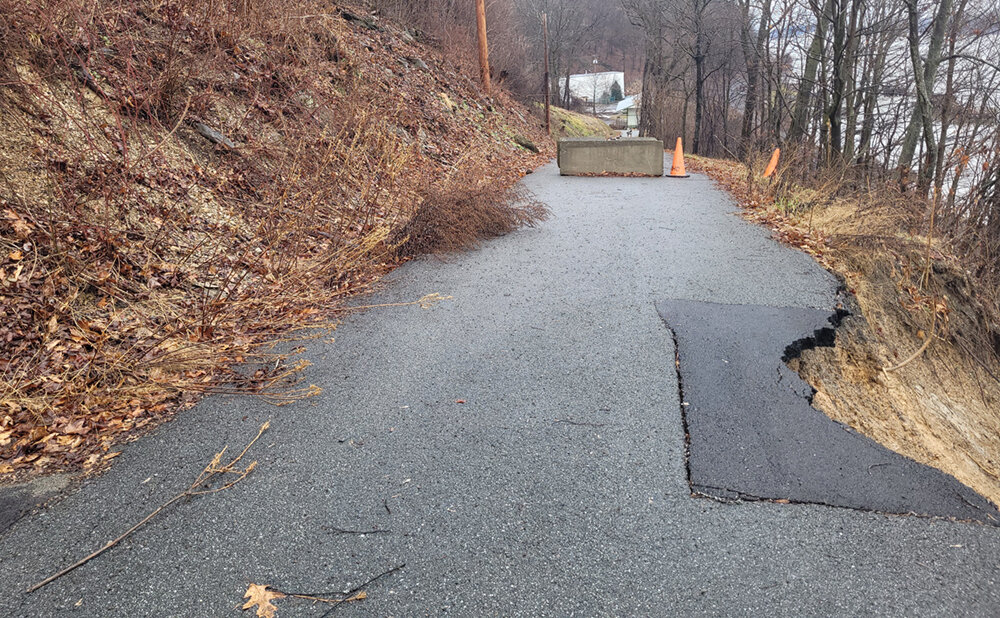 The road patch collapsed and slid down the cliff.